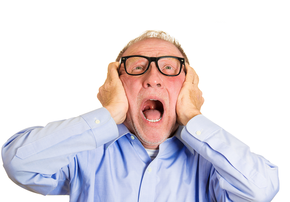 Closeup portrait, angry senior man, nerd black glasses, covering ears, looking up, to say, stop making that loud noise its giving me a headache, isolated white background. Negative human emotion Closeup portrait, angry senior man, nerd black glasses, covering ears, looking up, to say, stop making that loud noise its giving me a headache, isolated white background. Negative human emotion